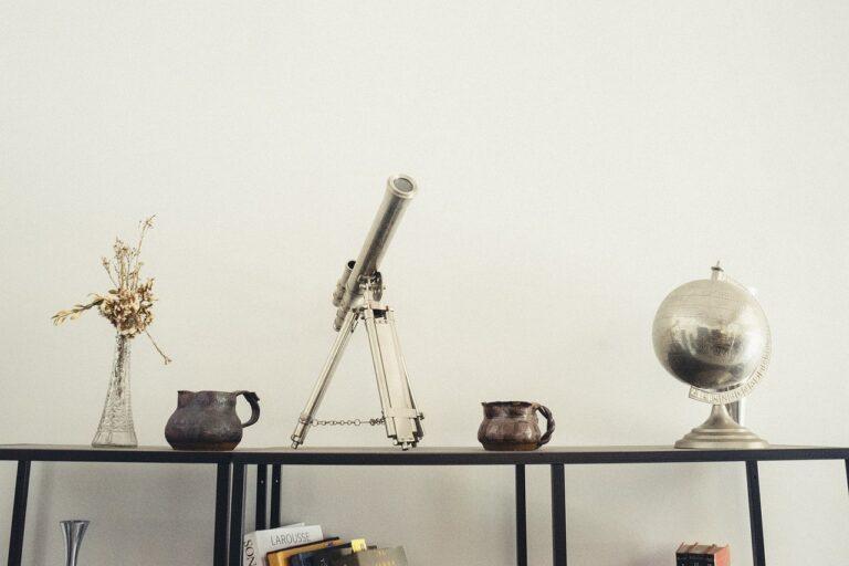 Shelf styled with telescope, globe and small ornaments