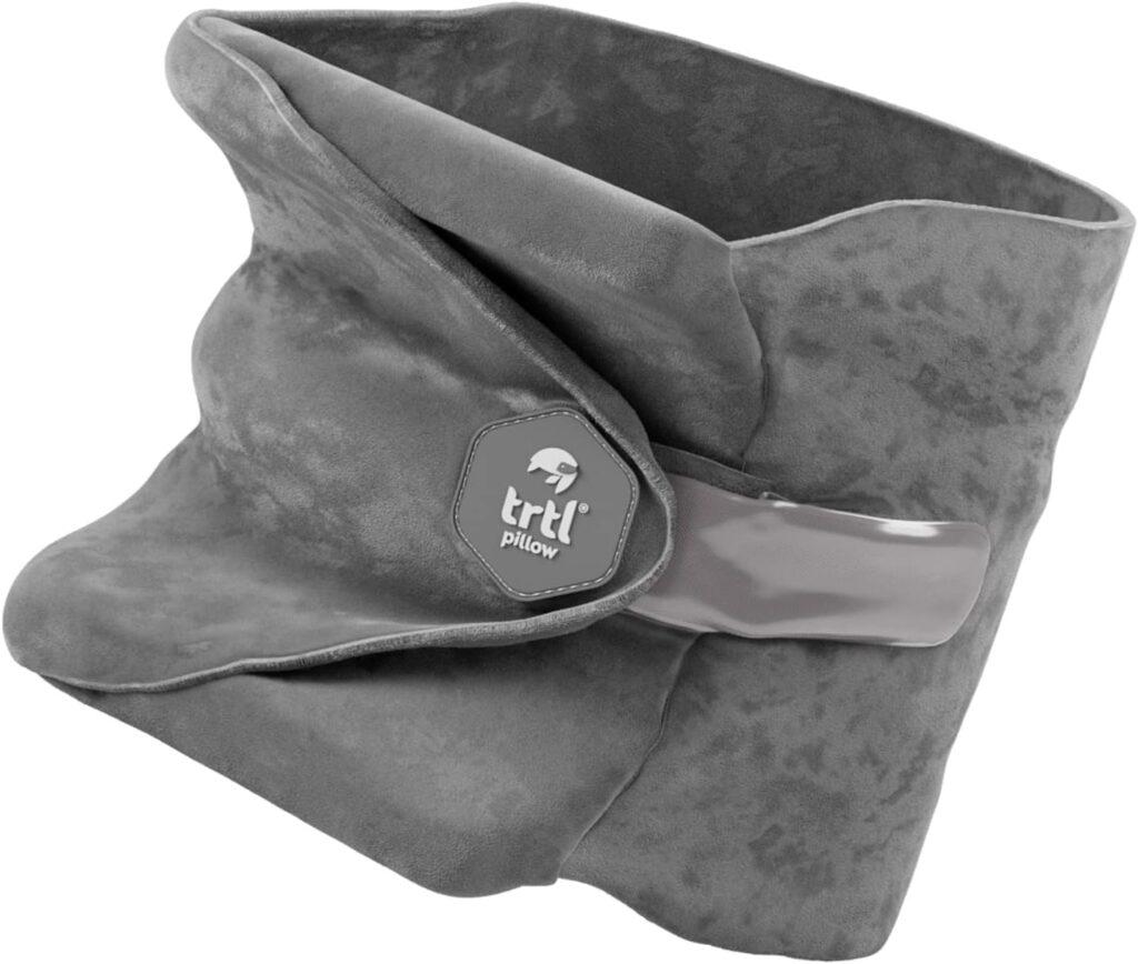 Image shows a grey travel pillow by TRTL as part of the blog Long-Haul Flight Tips for Ultimate Comfort, Rest, and Entertainment.