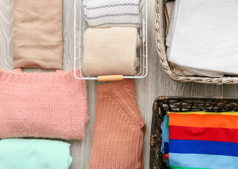 Image shows several baskets with folded laundry as part of the blog on mastering home organisation